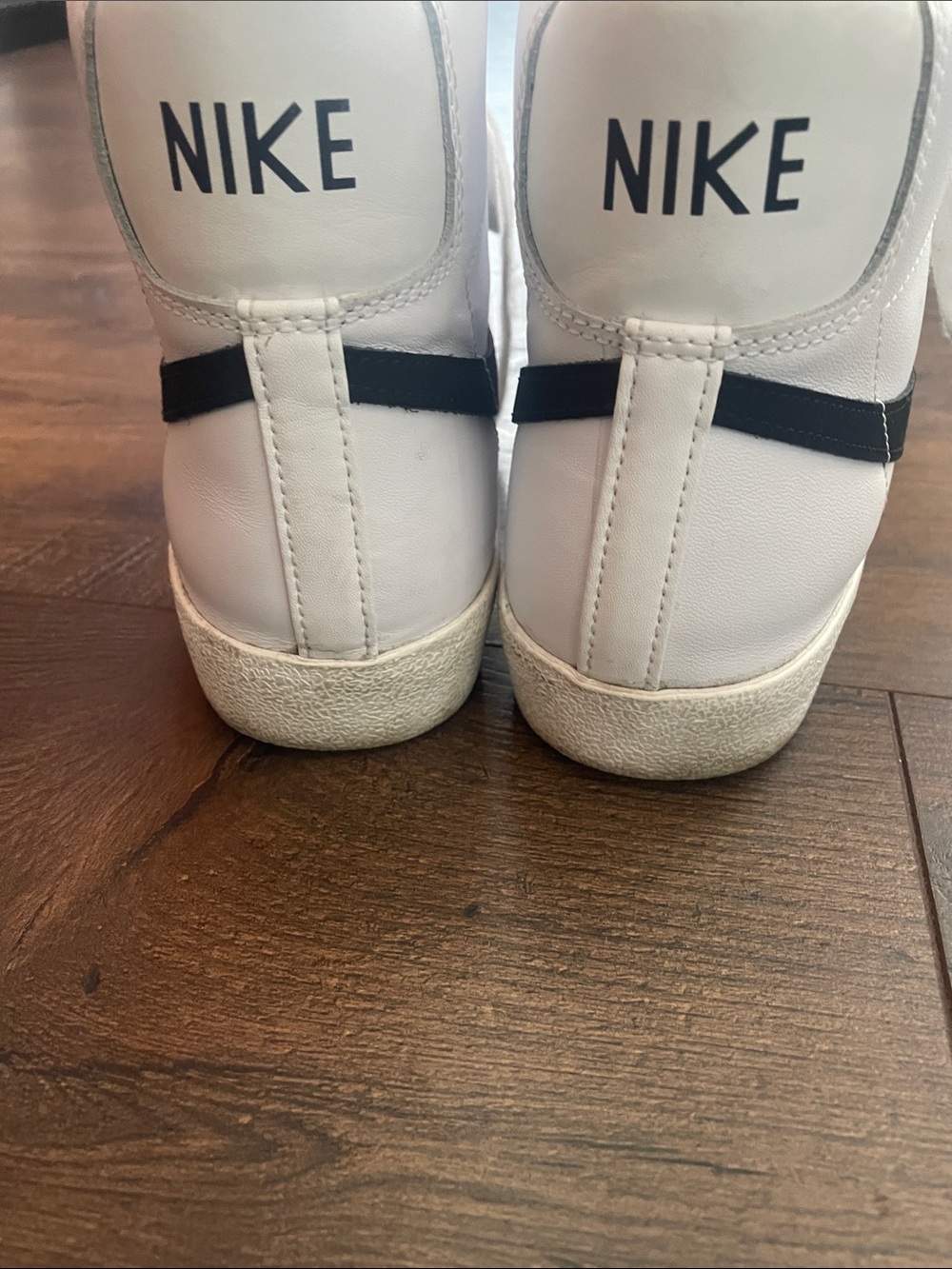 Nike White High-Top Sneakers with Black Swoosh